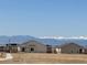 Residential home exterior with scenic mountain views and clear blue sky backdrop at 17942 E 94Th Pl, Commerce City, CO 80022