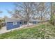 Wide view of a backyard showing the lawn, patio, and a storage shed at 9921 Wigham St, Thornton, CO 80229