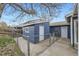 Fenced backyard features a blue storage shed with a concrete walkway at 9921 Wigham St, Thornton, CO 80229