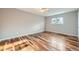 This is a light, neutral bedroom with natural light and wood floors at 9921 Wigham St, Thornton, CO 80229