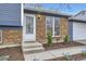 Close-up of a charming brick home, highlighting the front door, address, and neatly manicured landscaping at 9921 Wigham St, Thornton, CO 80229