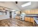 Open concept kitchen with wood floors, light wood cabinets, and bright natural light at 9921 Wigham St, Thornton, CO 80229