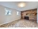 Cozy living room featuring a brick fireplace and two windows at 9921 Wigham St, Thornton, CO 80229