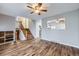 Spacious living room featuring hardwood floors, staircase, and a view into the kitchen area at 9921 Wigham St, Thornton, CO 80229