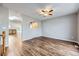 Open living area boasts beautiful floors, neutral paint, and a glimpse into the adjacent kitchen at 9921 Wigham St, Thornton, CO 80229
