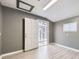 Bright room featuring neutral walls, modern floors, an exterior door, and a window at 9921 Wigham St, Thornton, CO 80229