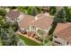 Aerial view of a well-maintained backyard with mature trees, an outdoor kitchen, and a hot tub at 7053 S Shawnee St, Aurora, CO 80016