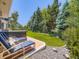 Beautifully landscaped backyard with lush green lawn, a hot tub and comfortable lounge seating at 7053 S Shawnee St, Aurora, CO 80016