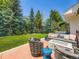 Inviting backyard patio with a firepit, comfortable seating and a lush green lawn at 7053 S Shawnee St, Aurora, CO 80016