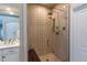 Modern bathroom with a glass-enclosed shower featuring stylish tile work and a built-in bench at 7053 S Shawnee St, Aurora, CO 80016