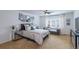Comfortable bedroom with neutral walls, ceiling fan, and a gallery wall with framed pictures at 7053 S Shawnee St, Aurora, CO 80016