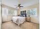 Bright bedroom featuring a cozy bed, ceiling fan, and natural light from windows at 7053 S Shawnee St, Aurora, CO 80016