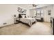 Comfortable bedroom featuring a ceiling fan, a large window and plush carpet at 7053 S Shawnee St, Aurora, CO 80016