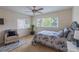 Bright and airy bedroom with large windows, a cozy chair, and a ceiling fan for added comfort at 7053 S Shawnee St, Aurora, CO 80016