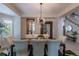 Beautiful dining room with modern chandelier, large mirror, and adjacent staircase at 7053 S Shawnee St, Aurora, CO 80016