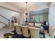 Elegant dining room with stylish light fixture and comfortable seating at 7053 S Shawnee St, Aurora, CO 80016