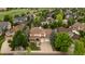 A grand two-story house features a spacious driveway and a meticulously landscaped front yard at 7053 S Shawnee St, Aurora, CO 80016