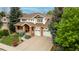A stately home with a manicured lawn, three-car garage and inviting front porch at 7053 S Shawnee St, Aurora, CO 80016