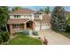 Beautifully landscaped two-story home featuring a spacious driveway and an inviting front porch at 7053 S Shawnee St, Aurora, CO 80016