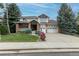 Charming two-story home with brick accents, manicured lawn, and well-maintained landscaping at 7053 S Shawnee St, Aurora, CO 80016