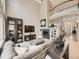 Spacious living room featuring a cozy sectional sofa, fireplace, and open floor plan at 7053 S Shawnee St, Aurora, CO 80016