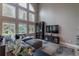 Cozy living room with high ceilings, large windows, and comfortable seating at 7053 S Shawnee St, Aurora, CO 80016
