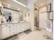 Luxurious main bathroom featuring a double vanity, walk-in shower, and modern finishes at 7053 S Shawnee St, Aurora, CO 80016