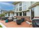 Outdoor patio with modern furniture, fire pit, barbecue, and relaxing hot tub at 7053 S Shawnee St, Aurora, CO 80016