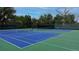 A bright blue tennis court with green trim and a black fence surround offer a wonderful sport activity at 7053 S Shawnee St, Aurora, CO 80016