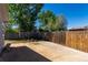 This backyard has a large concrete patio and is surrounded by a privacy fence at 205 Spruce Ave, Lochbuie, CO 80603