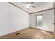 Bedroom with light wood floor, ceiling fan, and large window at 205 Spruce Ave, Lochbuie, CO 80603