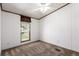 Simple bedroom with window featuring outside views, neutral walls and carpet at 205 Spruce Ave, Lochbuie, CO 80603