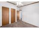Bedroom with three wooden doors, neutral walls and carpet at 205 Spruce Ave, Lochbuie, CO 80603