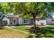 Charming single-story home with gray siding, landscaped front yard and a paved walkway at 205 Spruce Ave, Lochbuie, CO 80603