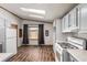 Bright kitchen featuring light-colored cabinets, laminate flooring and modern appliances at 205 Spruce Ave, Lochbuie, CO 80603