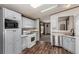 Cozy kitchen with light blue cabinets, stainless steel appliances, and wood-look floors at 205 Spruce Ave, Lochbuie, CO 80603