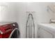 This laundry room has modern washer and dryer units and shelving at 205 Spruce Ave, Lochbuie, CO 80603