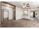 Open concept living room featuring neutral walls, cozy carpeting and views to the bathroom at 205 Spruce Ave, Lochbuie, CO 80603