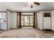 Sun-filled living room with neutral walls, and large window and adjacent kitchen at 205 Spruce Ave, Lochbuie, CO 80603