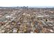 Aerial view showcases a neighborhood with tree-lined streets and a city skyline backdrop at 460 S Sherman St, Denver, CO 80209