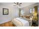 Charming bedroom with hardwood floors, a ceiling fan, and a comfortable white metal frame bed at 460 S Sherman St, Denver, CO 80209