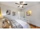 Bright bedroom with modern artwork, hardwood floors, ceiling fan, and comfortable white metal frame bed at 460 S Sherman St, Denver, CO 80209