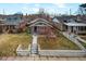 Charming bungalow with a well-maintained front yard, concrete steps and small tree at 460 S Sherman St, Denver, CO 80209