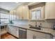 Spacious kitchen with white cabinets, granite countertops, and subway tile backsplash at 460 S Sherman St, Denver, CO 80209