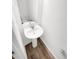 Small bathroom with pedestal sink and wood-look flooring at 810 N Vandriver Way, Aurora, CO 80018