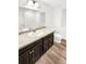 Bathroom with dark brown vanity and tile flooring at 810 N Vandriver Way, Aurora, CO 80018