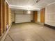 Unfinished garage with overhead door and ample space at 810 N Vandriver Way, Aurora, CO 80018