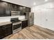 Kitchen boasts stainless steel appliances and dark cabinetry at 810 N Vandriver Way, Aurora, CO 80018