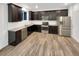 Modern kitchen with dark cabinets and stainless steel appliances at 810 N Vandriver Way, Aurora, CO 80018