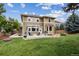 Spacious backyard with a well-manicured lawn and patio area at 2934 Braeburn Way, Highlands Ranch, CO 80126